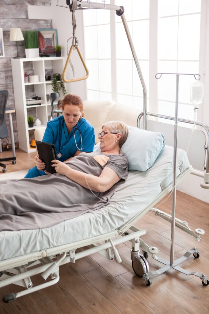 Female doctor helping old woman in nursing home